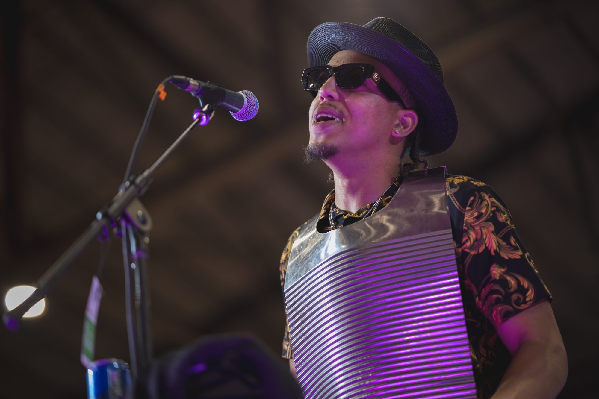 A rubboard player performs on stage.